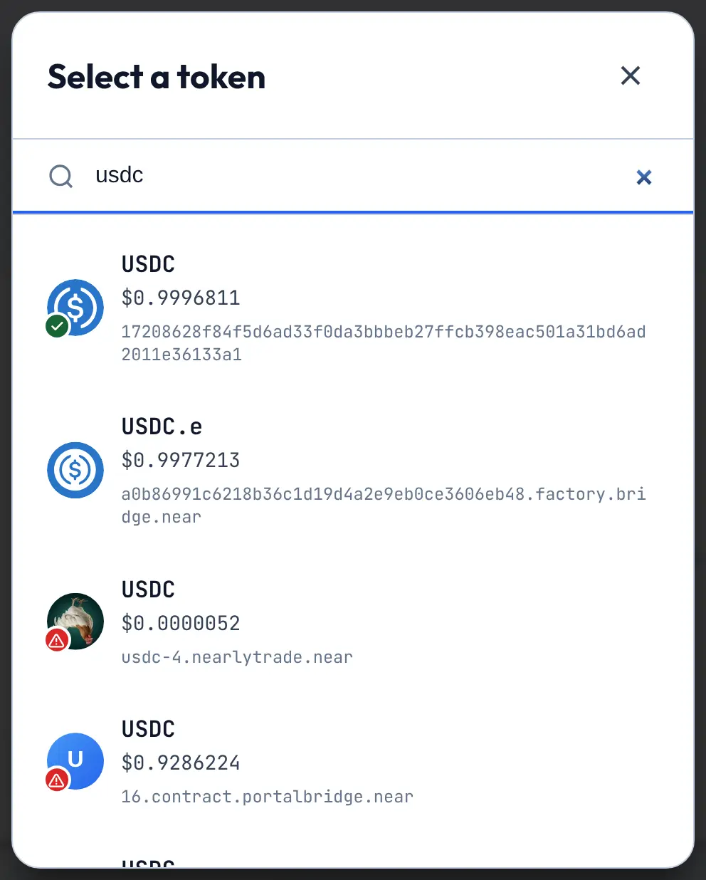 Token search for USDC showing the verified USDC with a green check and look-alike USDC tokens with red warning badges